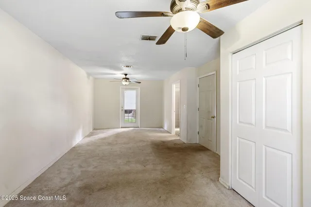 en view interior of a house with a ceiling fan and window