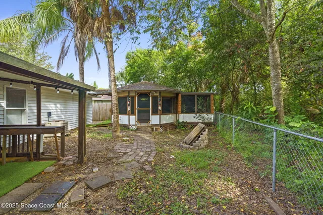 a view of a house with backyard porch and sitting area