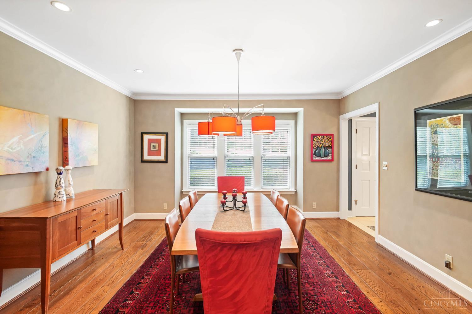 2780 Walsh Road Cincinnati, OH 45208 - Photo 22 of 68 The beautifully appointed formal dining room is designed for both everyday living and elegant entertaining. Anchored by rich hardwood floors, crown molding and a statement chandelier, the space is warm and inviting with generous proportions for hosting. Large windows bring in natural light, while seamless connectivity to adjacent living areas ensures an effortless flow for gatherings both large and small.