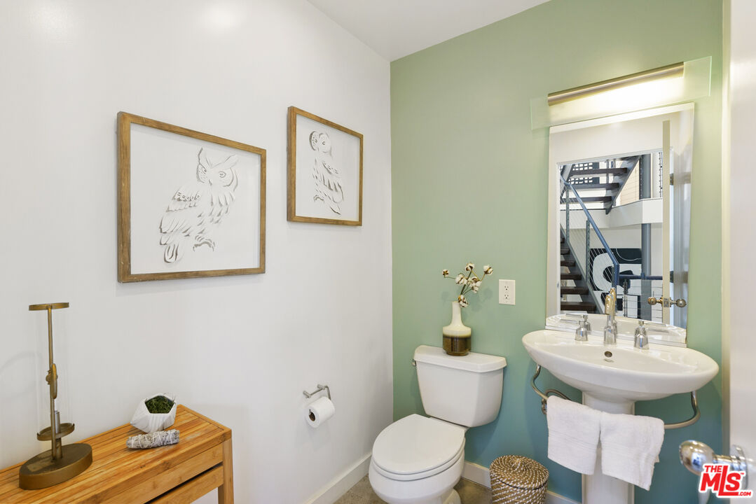 1228 21st Street, Unit D Santa Monica, CA 90404 - Photo 12 of 32 a bathroom with a sink mirror and toilet
