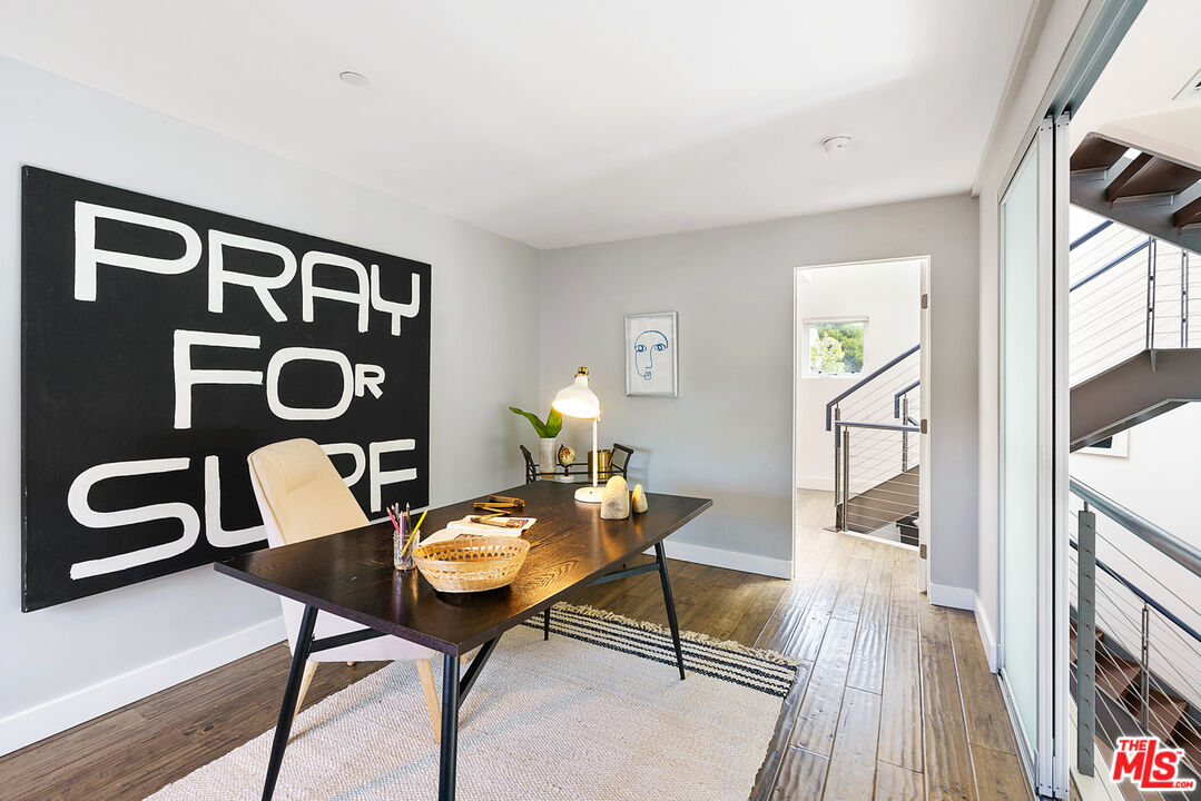 1228 21st Street, Unit D Santa Monica, CA 90404 - Photo 16 of 32 a dining room with wooden floor a glass table and chairs