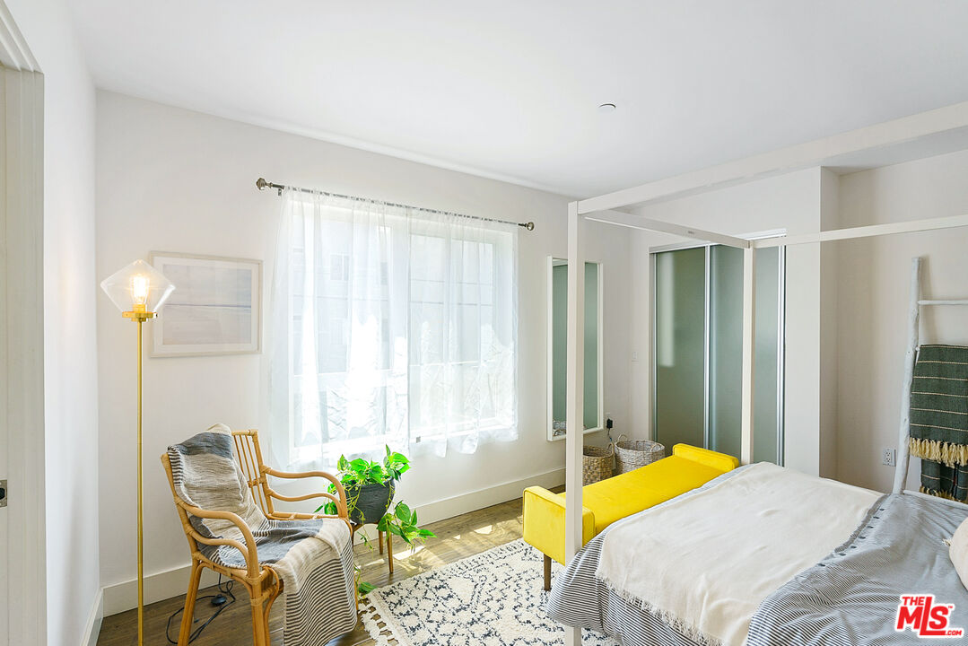1228 21st Street, Unit D Santa Monica, CA 90404 - Photo 19 of 32 a bedroom with a bed table chair and a window