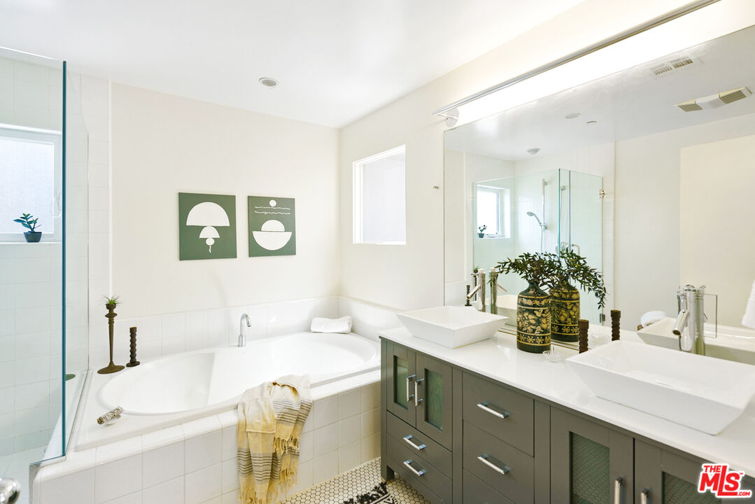 1228 21st Street, Unit D Santa Monica, CA 90404 - Photo 26 of 32 a bathroom with a tub sink and mirror