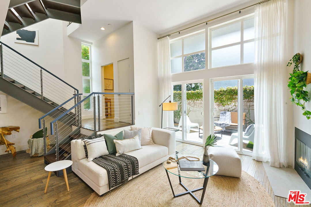 1228 21st Street, Unit D Santa Monica, CA 90404 - Photo 3 of 32 a living room with furniture and a large window