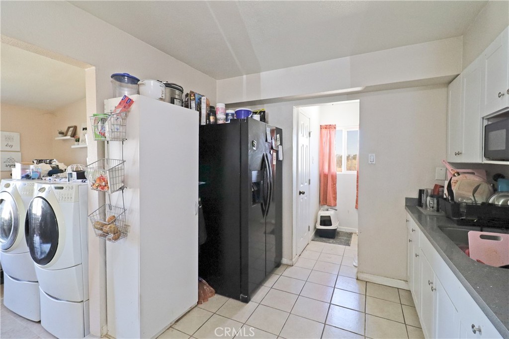 25466 Jasper Road Barstow, CA 92311 - Photo 13 of 32 a kitchen with a refrigerator and washer