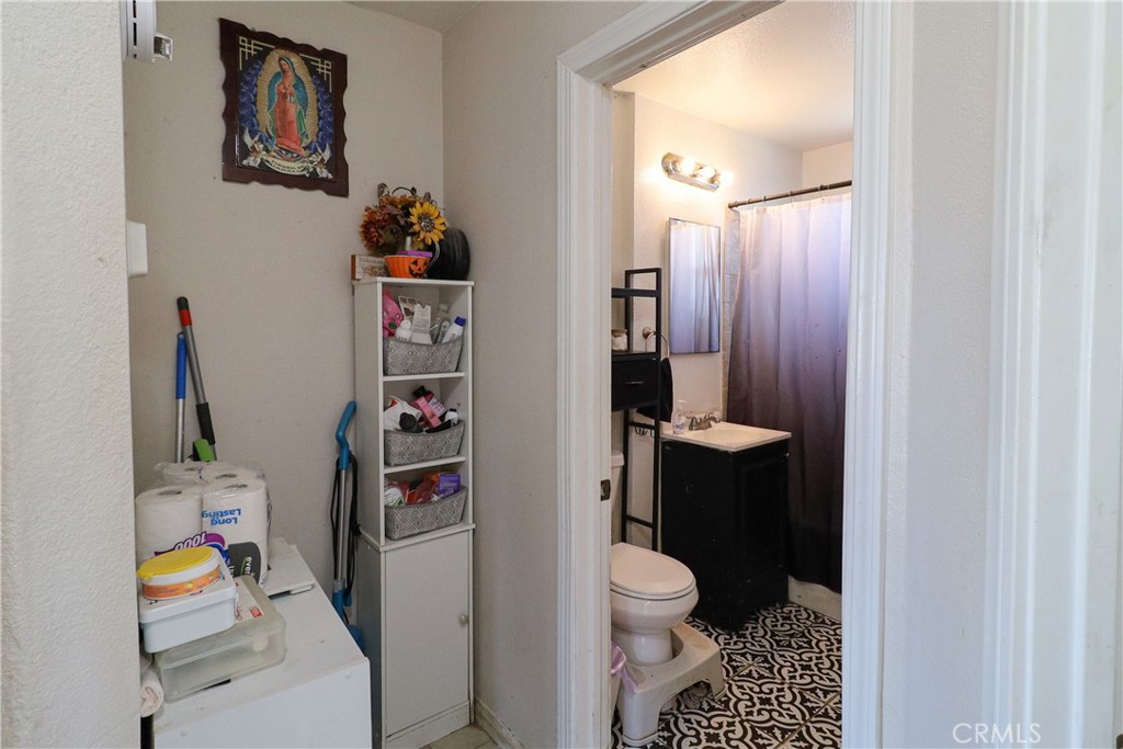 25466 Jasper Road Barstow, CA 92311 - Photo 19 of 32 a bathroom with a toilet and a shower curtain
