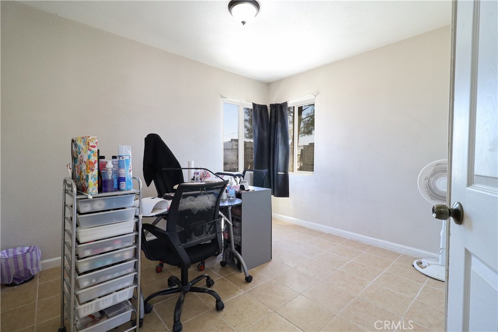 25466 Jasper Road Barstow, CA 92311 - Photo 22 of 32 a view of a workspace with furniture and a window