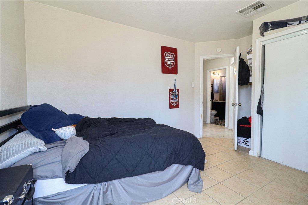 25466 Jasper Road Barstow, CA 92311 - Photo 26 of 32 a bedroom with a bed and a dresser