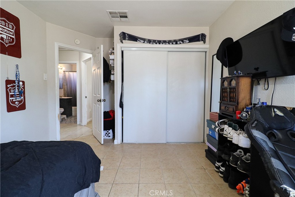 25466 Jasper Road Barstow, CA 92311 - Photo 27 of 32 a bedroom with a bed and a dresser