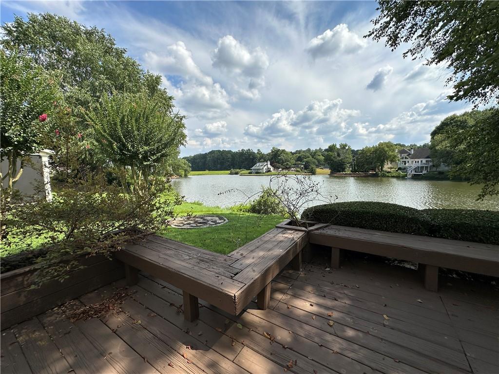 a view of a lake with couches in the patio