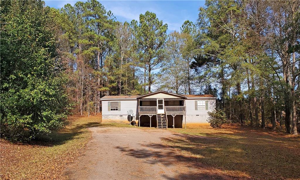 104 Extension Johnson Road Locust Grove, GA 30248 - Photo 1 of 1 a front view of a house with a yard and large trees
