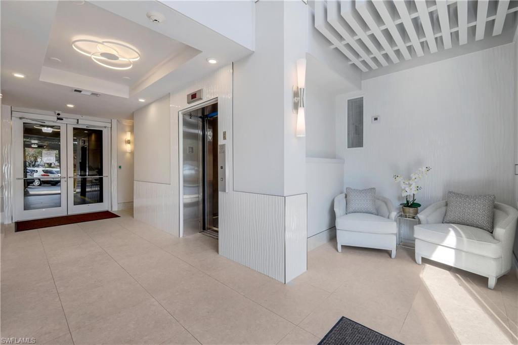 400 Flagship Drive, Unit 705 Naples, FL 34108 - Photo 14 of 25 a living room with furniture and a chandelier