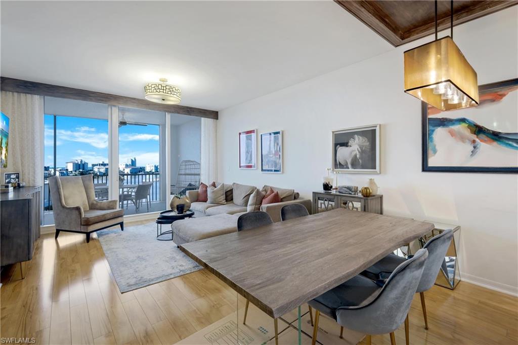 400 Flagship Drive, Unit 705 Naples, FL 34108 - Photo 5 of 25 a living room with dining room and wooden floor