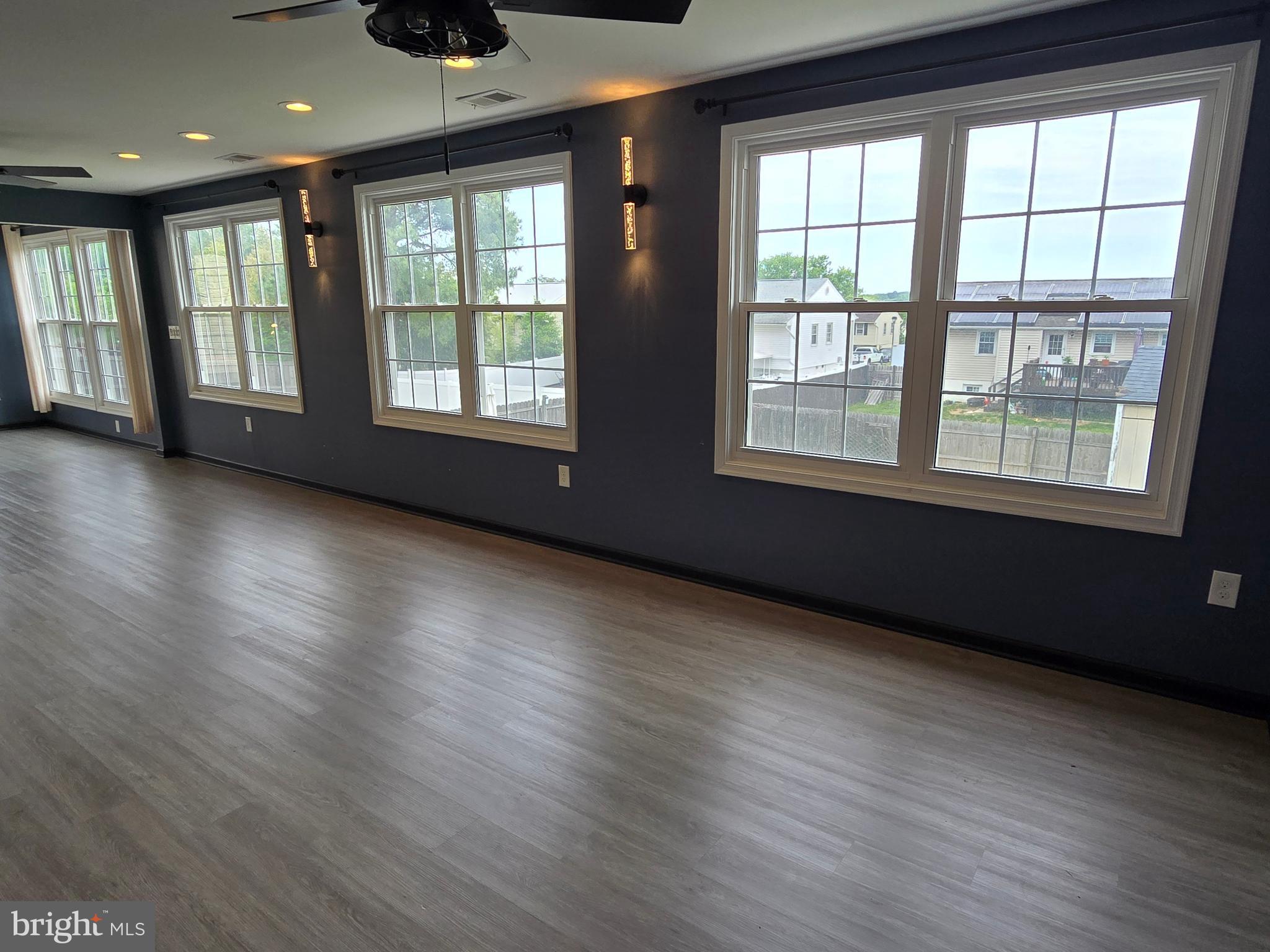 7513 Saffron Court Hanover, MD 21076 - Photo 13 of 42 a view of an empty room with wooden floor and a window