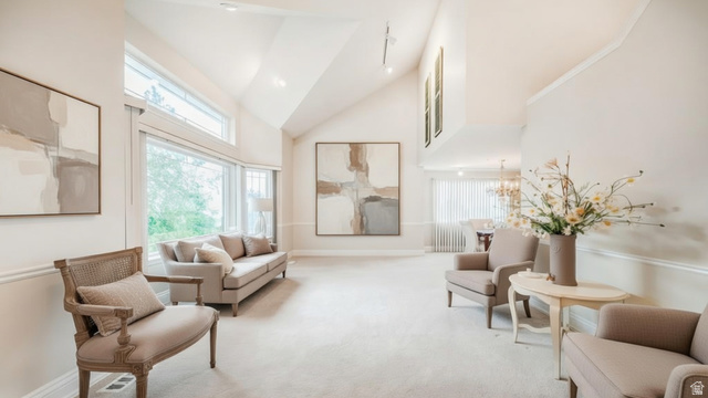 1273 Grayson Court Sandy, UT 84094 - Photo 5 of 27 Living area featuring vaulted ceilings, a bay window, upper transom windows, recessed lighting, and crown molding