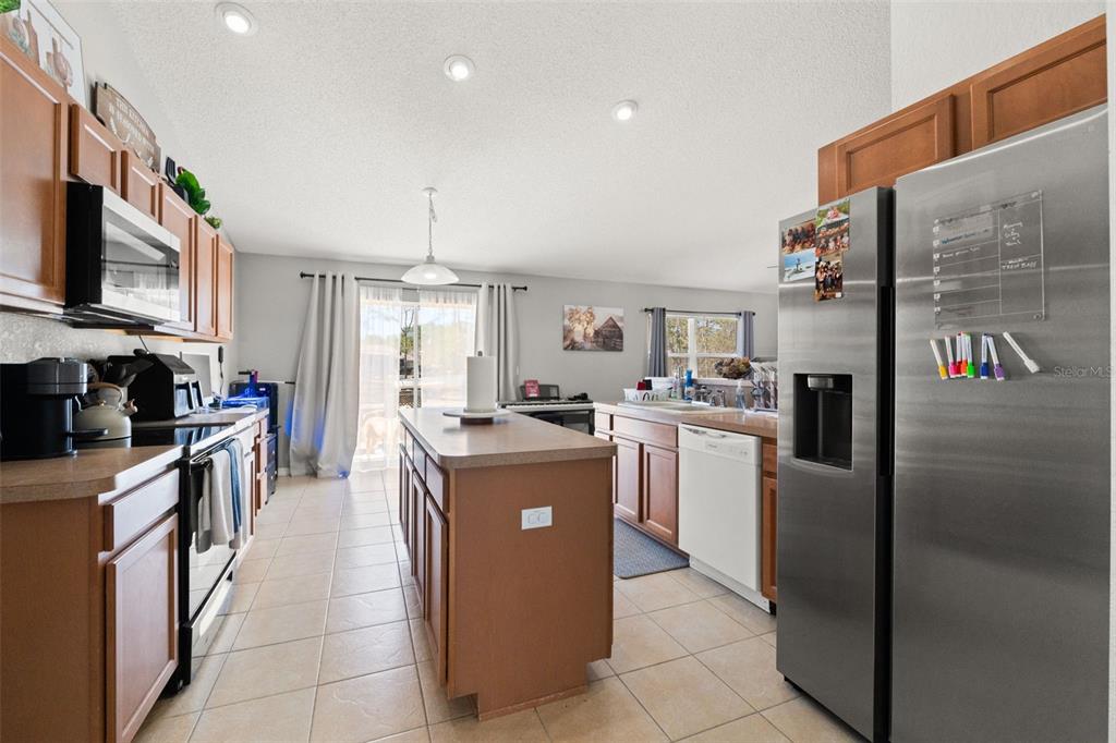 15335 Fleetwood Road Weeki Wachee, FL 34614 - Photo 23 of 40 a kitchen with stainless steel appliances granite countertop a refrigerator a stove and a sink