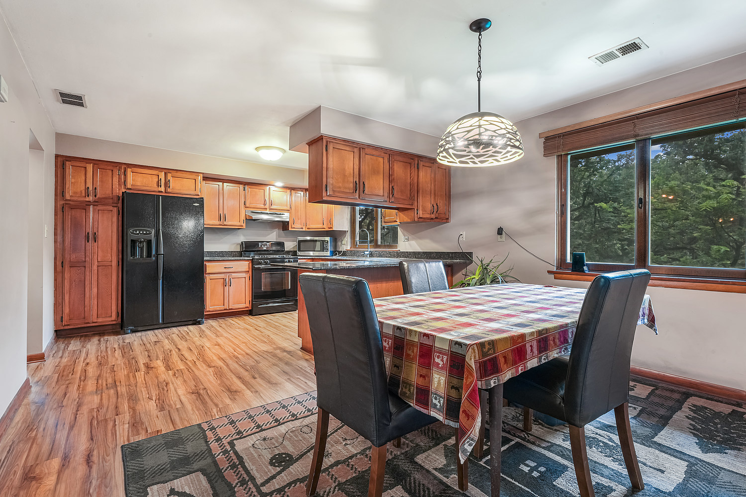 27960 South Klemme Road Beecher, IL 60401 - Photo 8 of 24 a outdoor dining room with stainless steel appliances kitchen island granite countertop furniture and a chandelier