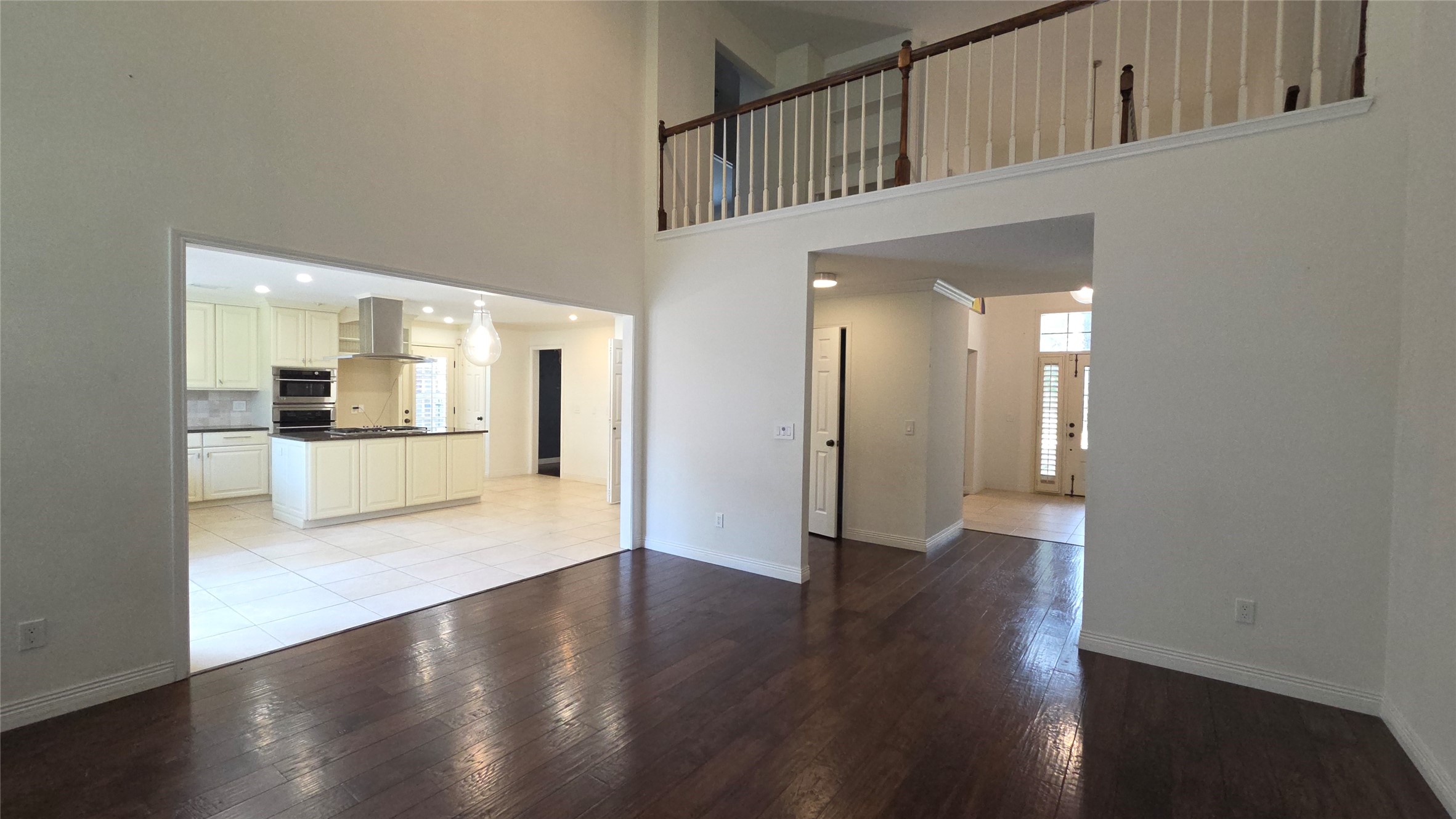 54 Thorn Berry Place Spring, TX 77381 - Photo 12 of 32 a view of a big room with wooden floor and a kitchen