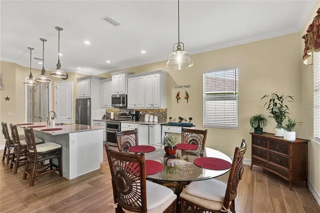 a large kitchen with a table and chairs
