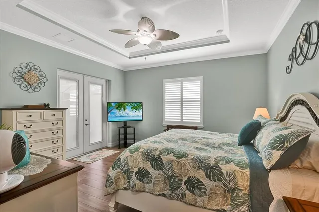 a bedroom with a bed and a chandelier