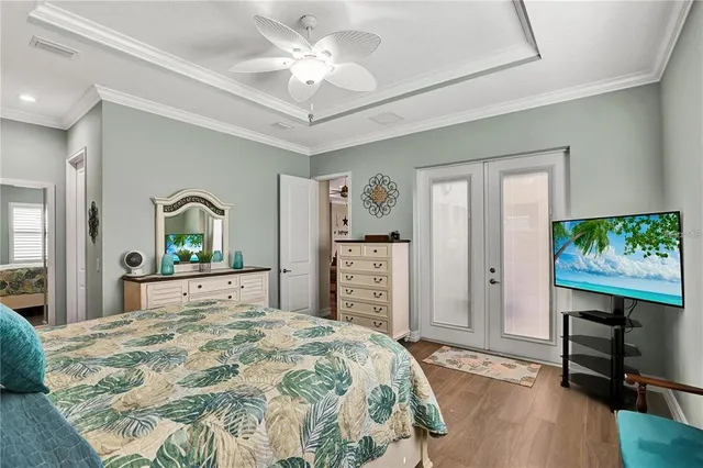 a bedroom with a bed dresser and a flat tv screen