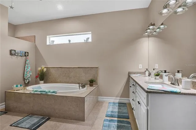 a bath room with a sink and a mirror