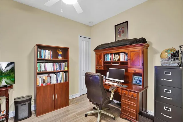 a view of a workspace with furniture and a bookshelf