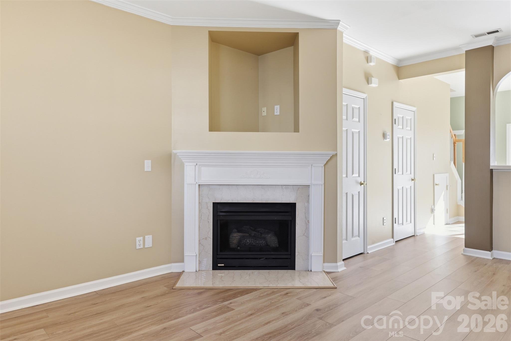727 Shellstone Place Fort Mill, SC 29708 - Photo 4 of 31 a view of an empty room with wooden floor and a fireplace