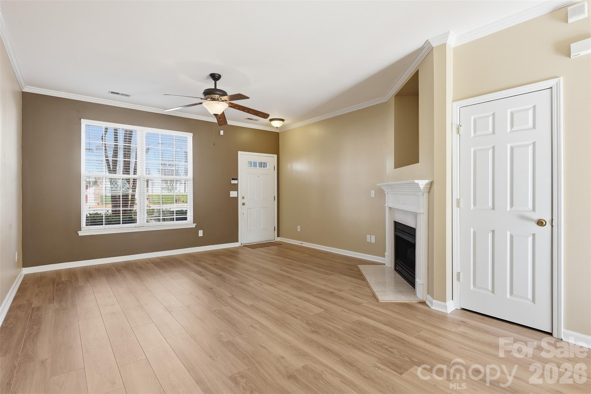 727 Shellstone Place Fort Mill, SC 29708 - Photo 5 of 31 a view of empty room with fireplace and wooden floor