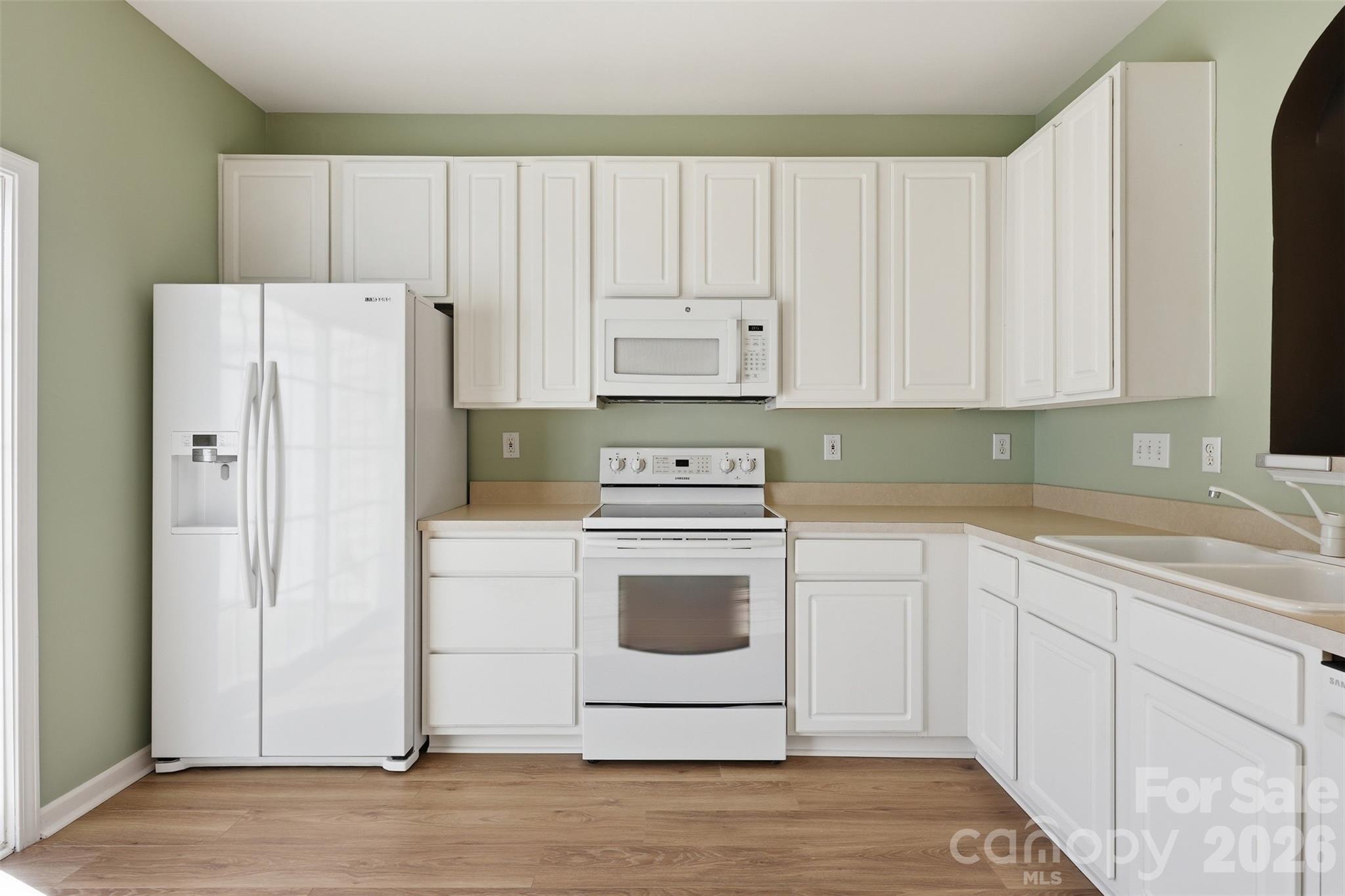 727 Shellstone Place Fort Mill, SC 29708 - Photo 9 of 31 a white kitchen with granite top and stainless steel appliances