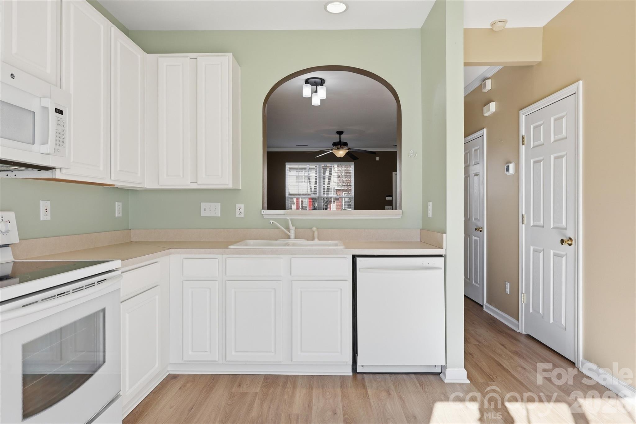 727 Shellstone Place Fort Mill, SC 29708 - Photo 10 of 31 a kitchen with granite countertop white cabinets and white appliances