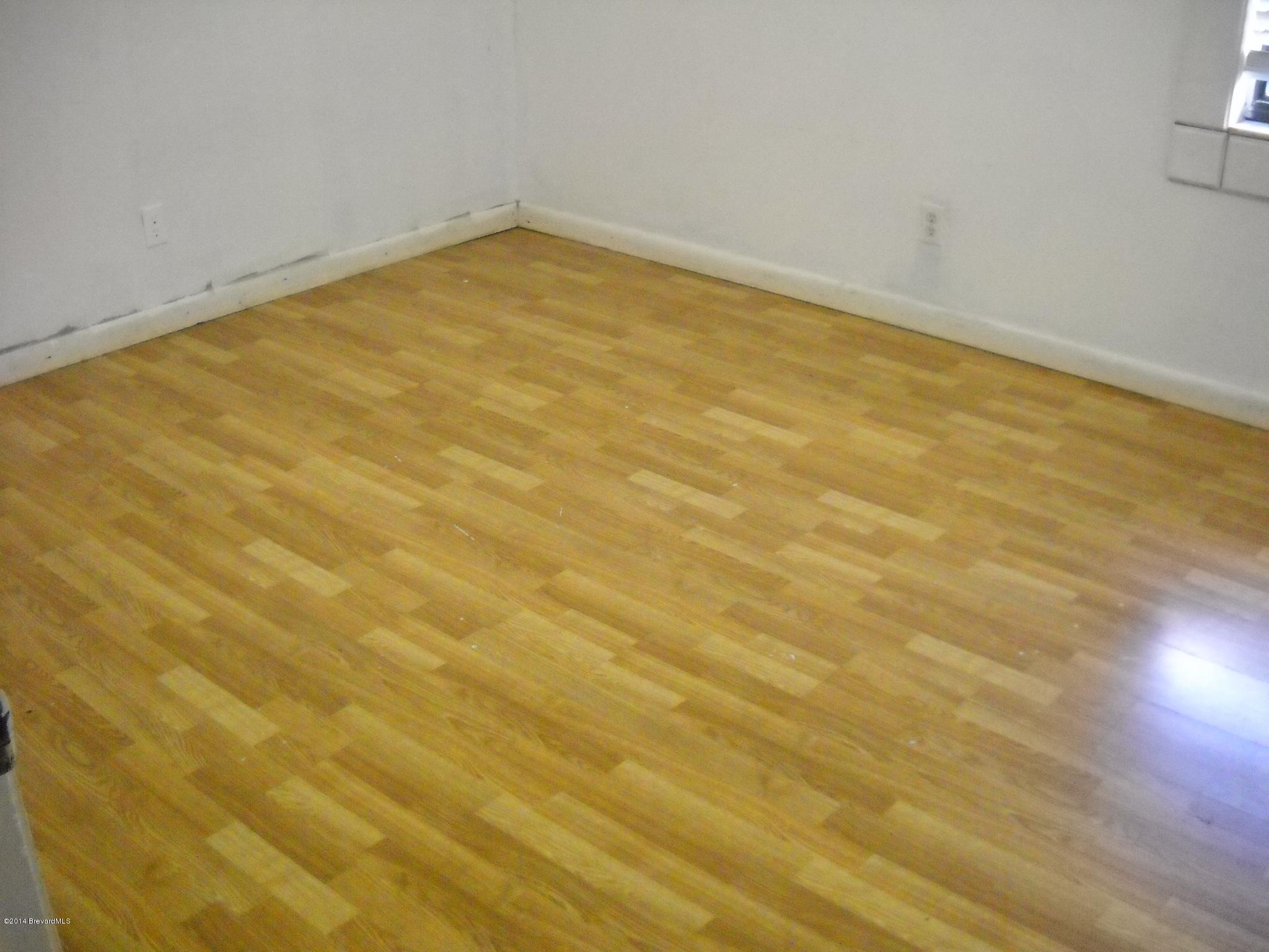 6498 Hunt Road Cocoa, FL 32927 - Photo 11 of 15 3rd bedroom wood flooring view