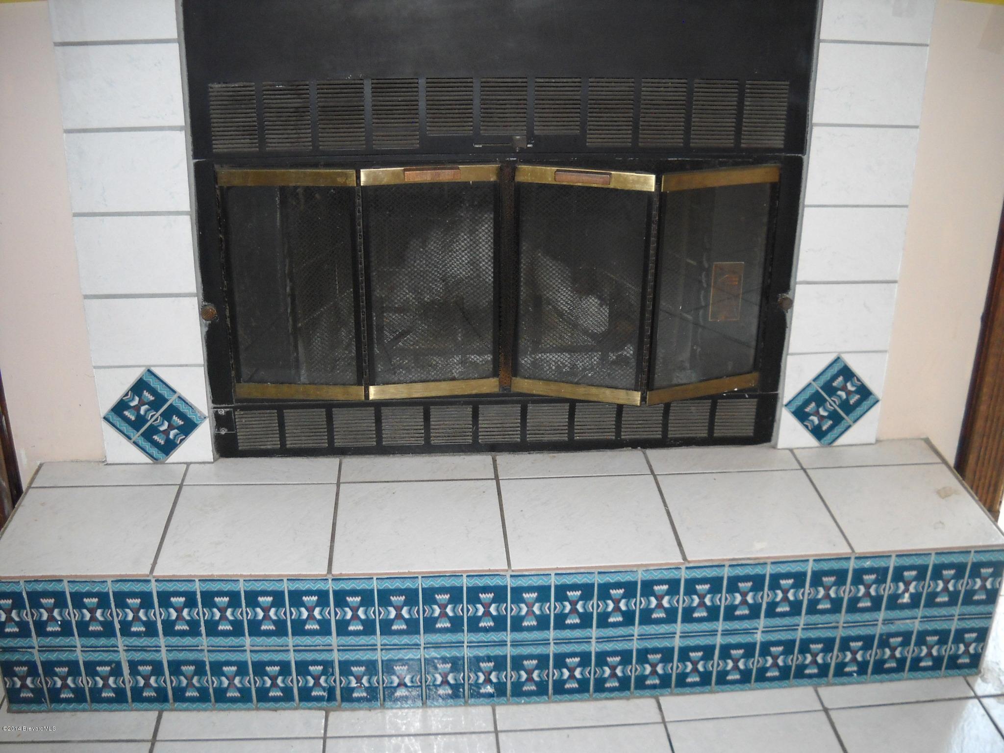 6498 Hunt Road Cocoa, FL 32927 - Photo 6 of 15 Wood burning fireplace in living room
