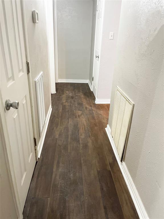 3924 Hunters Trail Mesquite, TX 75150 - Photo 11 of 23 a view of a hallway with wooden floor and staircase