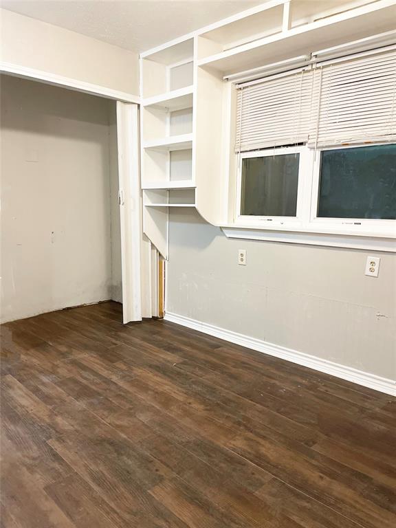 3924 Hunters Trail Mesquite, TX 75150 - Photo 16 of 23 a view of an empty room with wooden floor and a window