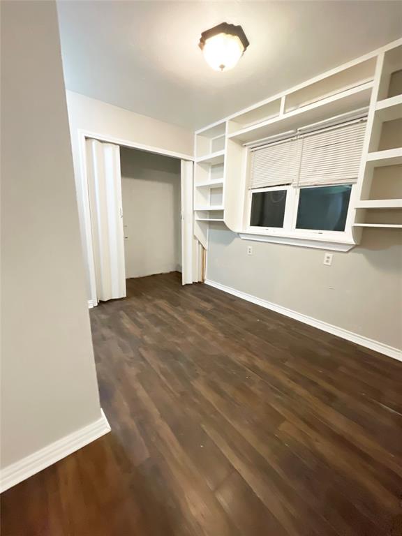 3924 Hunters Trail Mesquite, TX 75150 - Photo 17 of 23 a view of an empty room with wooden floor and a window
