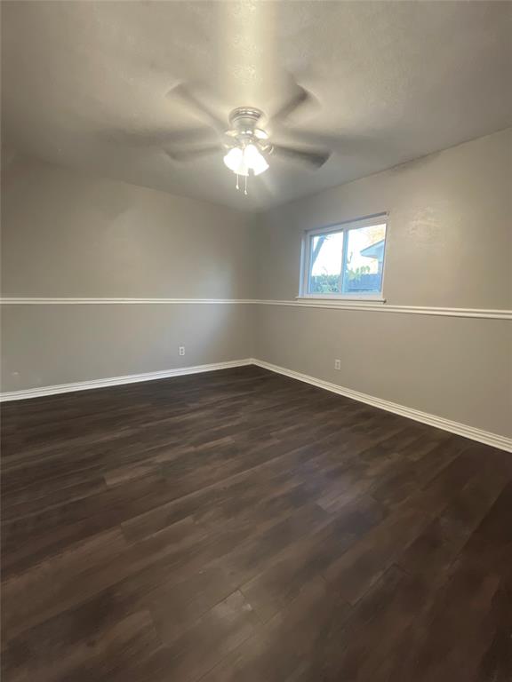 3924 Hunters Trail Mesquite, TX 75150 - Photo 21 of 23 an empty room with wooden floor and windows