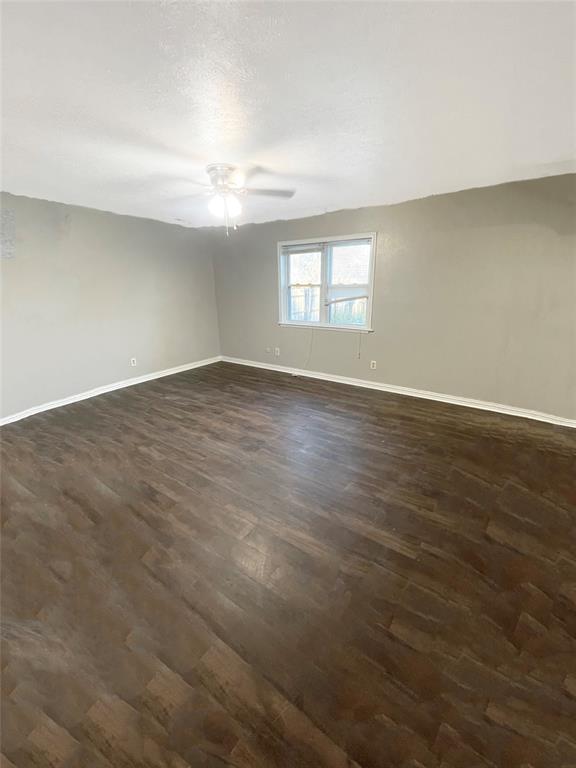 3924 Hunters Trail Mesquite, TX 75150 - Photo 22 of 23 an empty room with wooden floor and windows