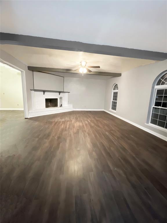 3924 Hunters Trail Mesquite, TX 75150 - Photo 5 of 23 a view of an empty room with a window and wooden floor