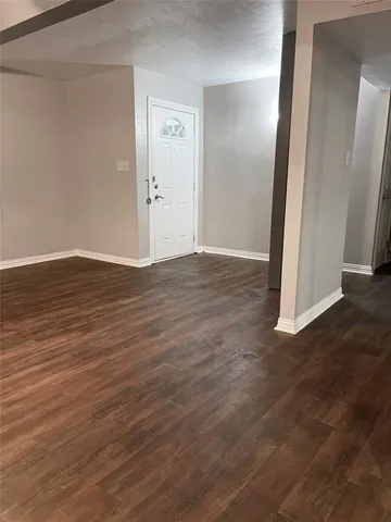 an empty room with wooden floor and closet