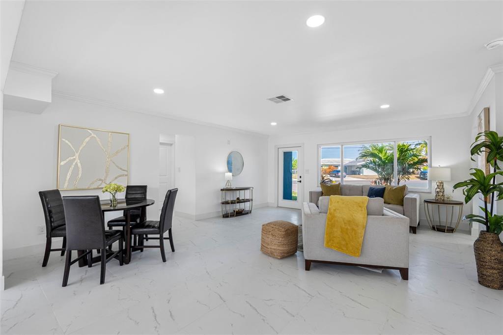 785 115th Avenue Treasure Island, FL 33706 - Photo 11 of 46 a view of a dining room with furniture and a livingroom