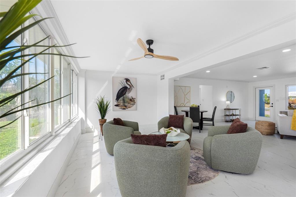 785 115th Avenue Treasure Island, FL 33706 - Photo 13 of 46 a living room with furniture or couch and a chandelier