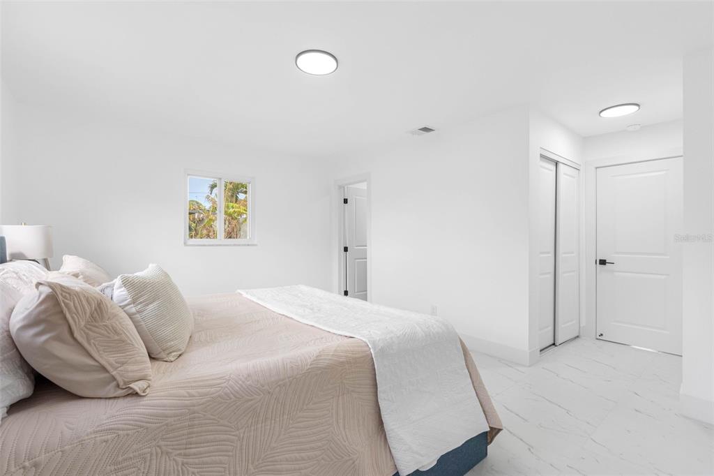 785 115th Avenue Treasure Island, FL 33706 - Photo 24 of 46 a bedroom with a bed and painting on the wall