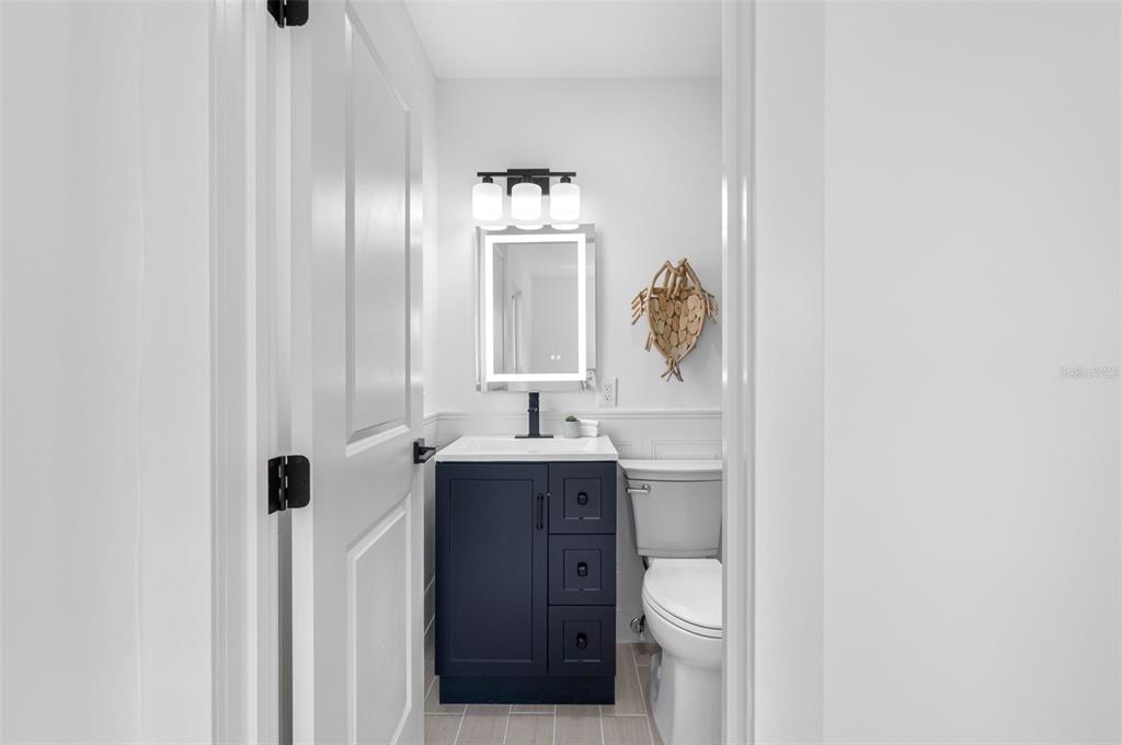 785 115th Avenue Treasure Island, FL 33706 - Photo 26 of 46 a bathroom with a sink a toilet and mirror