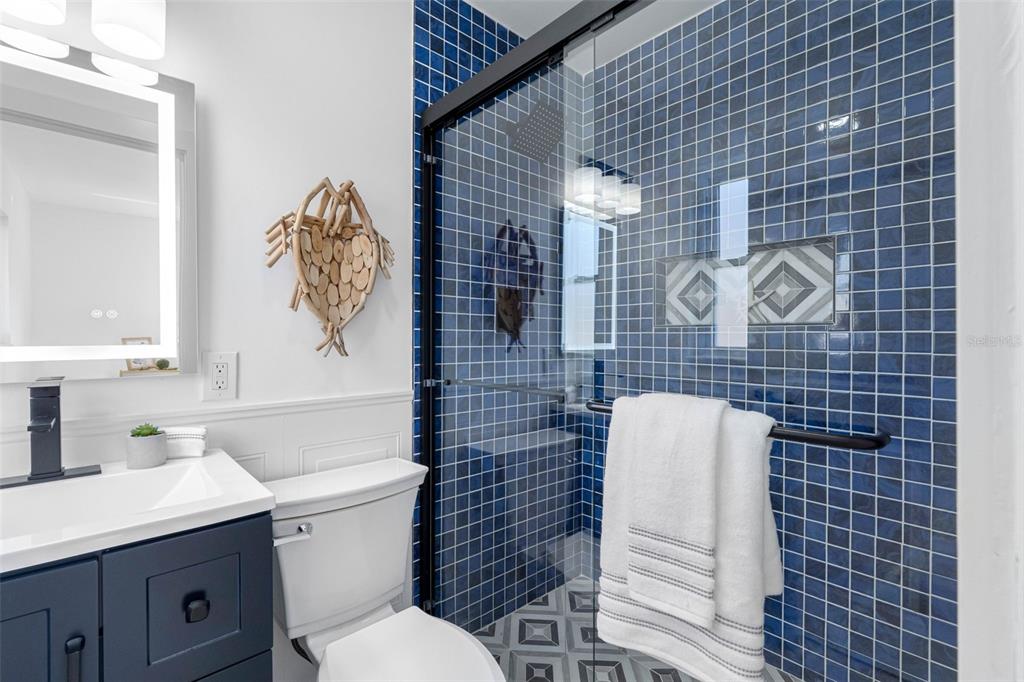 785 115th Avenue Treasure Island, FL 33706 - Photo 27 of 46 a bathroom with a toilet sink and mirror