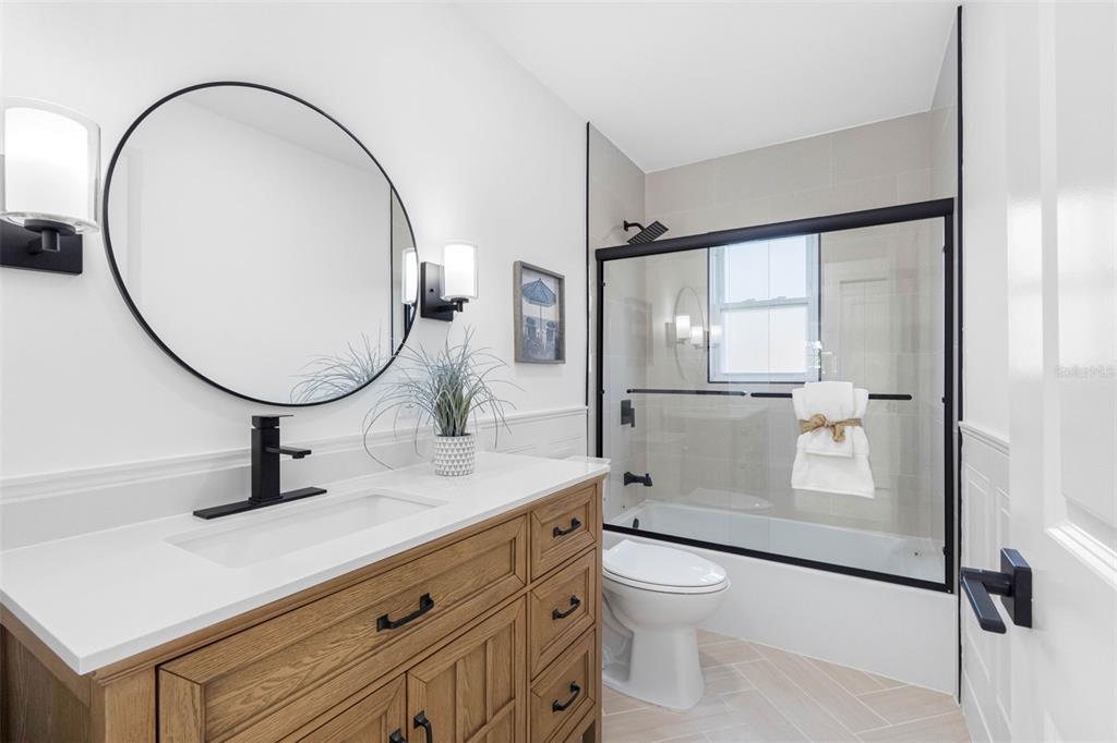 785 115th Avenue Treasure Island, FL 33706 - Photo 30 of 46 a bathroom with a sink a toilet and a mirror