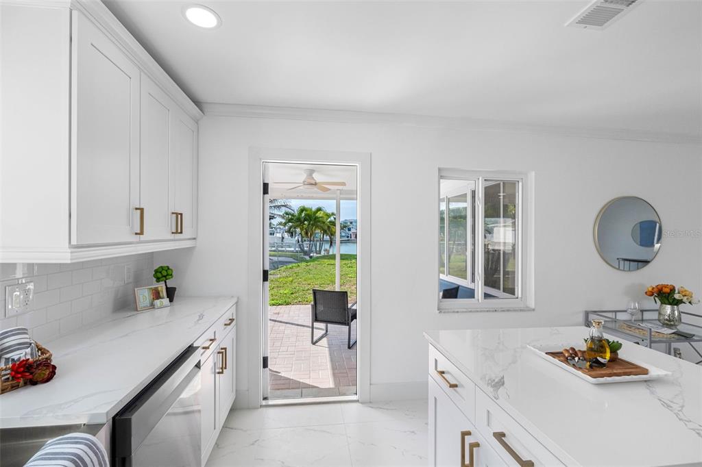785 115th Avenue Treasure Island, FL 33706 - Photo 33 of 46 a kitchen with a sink stove and cabinets