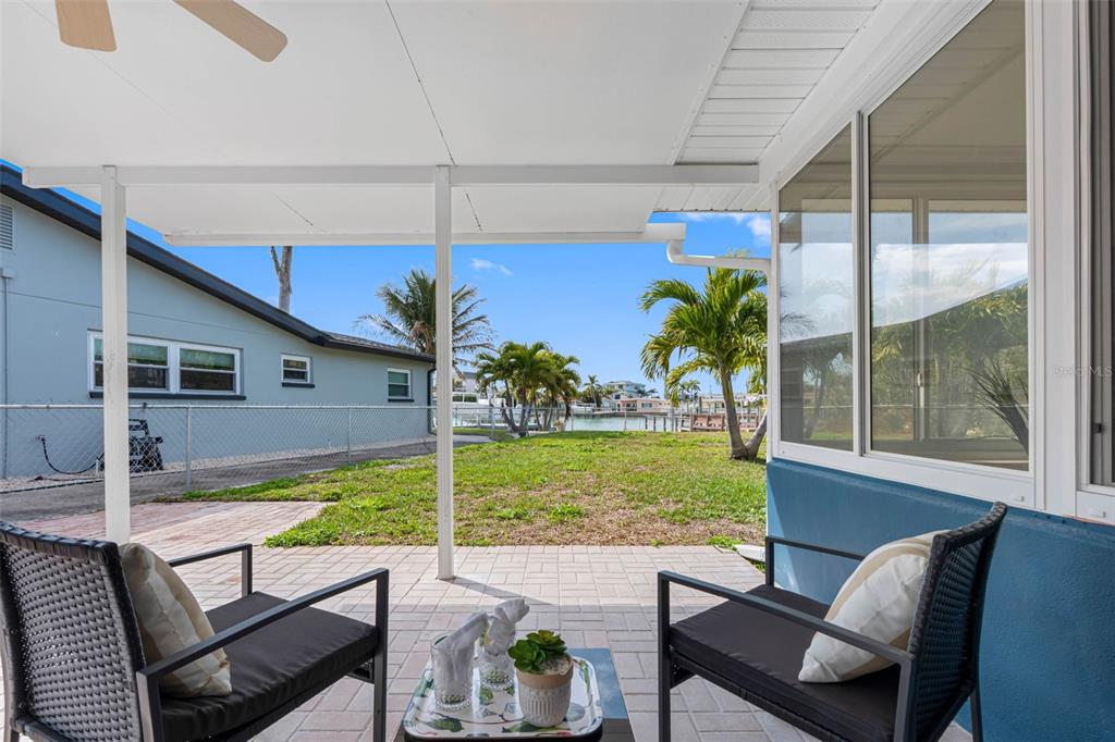 785 115th Avenue Treasure Island, FL 33706 - Photo 34 of 46 a view of a chair and tables in the patio