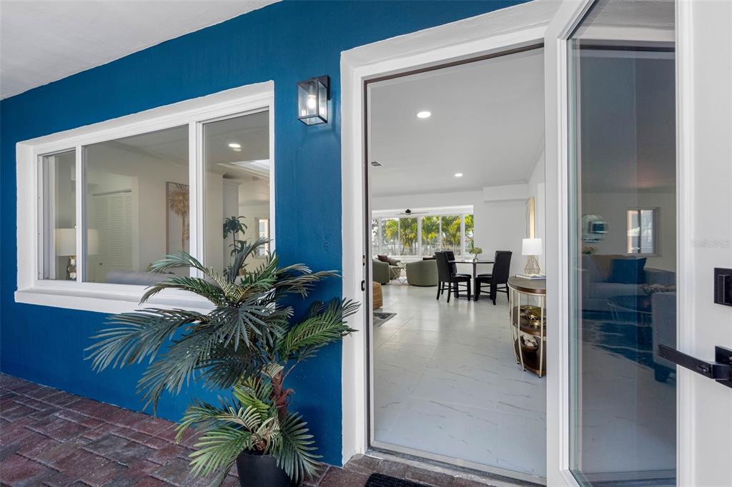 785 115th Avenue Treasure Island, FL 33706 - Photo 5 of 46 a hallway with a dining table and a potted plant