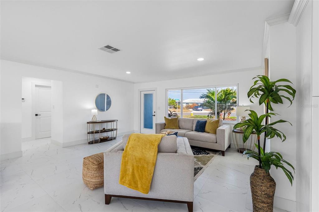 785 115th Avenue Treasure Island, FL 33706 - Photo 8 of 46 a living room with furniture potted plant and a potted plant